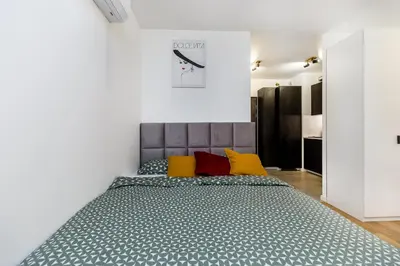 a bedroom with a large bed with yellow pillows at Cloud9 - Barska 69 in Kraków