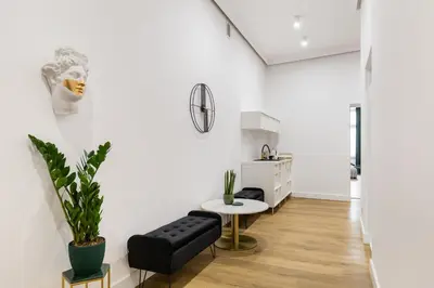 a living room with a black couch and a table at Oro Apartments in Kraków