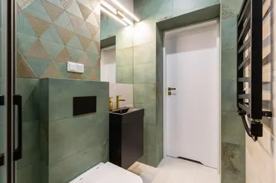 a bathroom with a toilet and a sink at Oro Apartments in Kraków