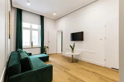 a living room with a couch and a tv at Oro Apartments in Kraków