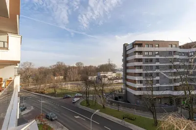 a view of a building and a road with cars at Glossy Apart G244 in Kraków