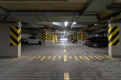 an empty parking garage with cars parked in it at Bunscha Apartment Dębniki Cracow by Noclegi Renters in Kraków
