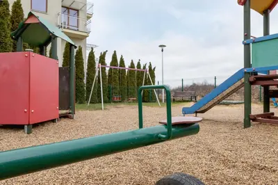 a playground with a slide and a swing set at Bunscha Apartment Dębniki Cracow by Noclegi Renters in Kraków