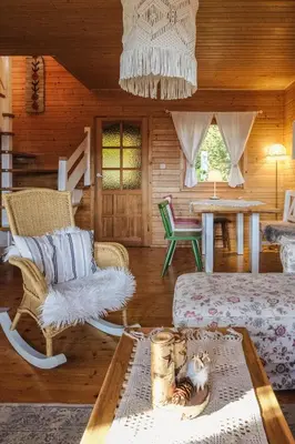 a living room with a couch and a table at Alemiło - uroczy dom z balią i widokiem na Babią Górę in Zawoja
