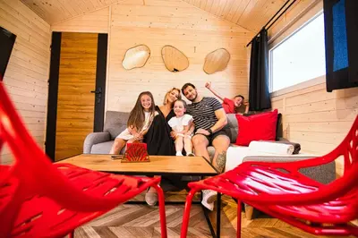 a man and two girls sitting on a bunk bed at Holiday Park Zator Resort & Spa in Zator