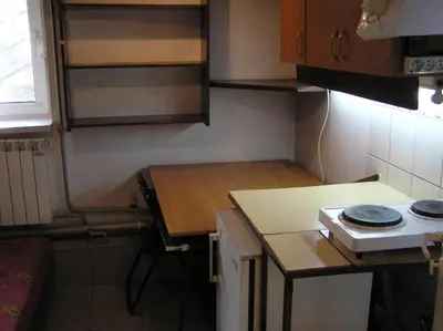 a small kitchen with a door and a sink at A-klimatyzacja kawalerka mała Halczyna 9 do Centrum 6 przystanków in Kraków