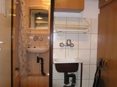 a bathroom with a sink and a mirror at A-klimatyzacja kawalerka mała Halczyna 9 do Centrum 6 przystanków in Kraków