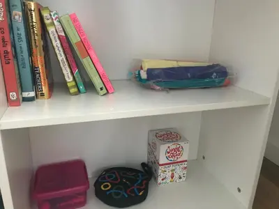 a white shelf with books and a box on it at Apartament Reformacka in Wieliczka