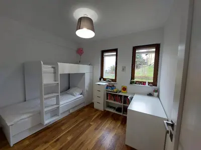a bedroom with a bunk bed and a desk at Apartament Reformacka in Wieliczka