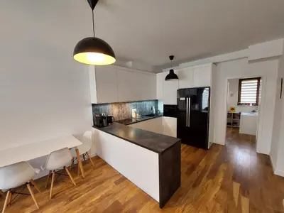 a kitchen with a counter and a table and chairs at Apartament Reformacka in Wieliczka