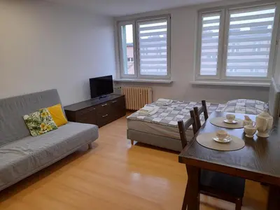 a living room with a couch and a table at Apartament 44 in Wadowice