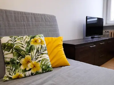 a kitchen with a couch and a table in a room at Apartament 44 in Wadowice