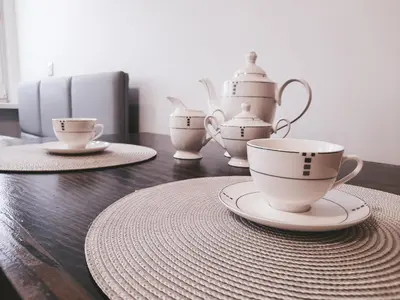 a kitchen with wooden cabinets and a couch with a pillow at Apartament 44 in Wadowice