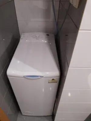 a white toilet in a bathroom with a wall at Apartament 44 in Wadowice