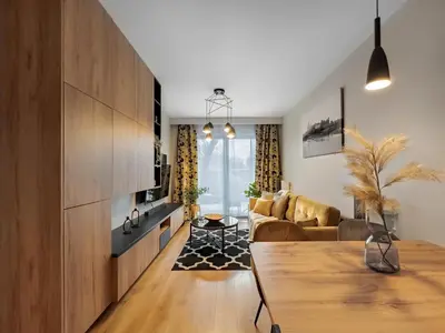a living room with a table and a couch at Apartament z dużym tarasem w centrum Krakowa in Kraków