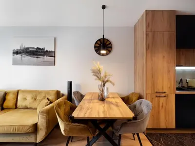 a living room with a table and a couch at Apartament z dużym tarasem w centrum Krakowa in Kraków