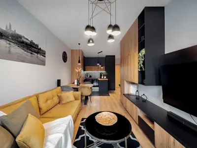 a living room with a couch and a table at Apartament z dużym tarasem w centrum Krakowa in Kraków