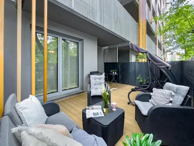 a balcony with couches and chairs on a building at Apartament z dużym tarasem w centrum Krakowa in Kraków