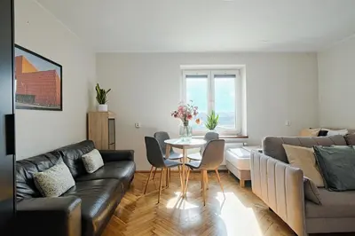 a living room with a couch and a table at Urban Nest Apartments Starowiślna 95 in Kraków