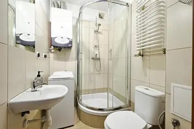 a bathroom with a sink and a toilet and a shower at Urban Nest Apartments Starowiślna 95 in Kraków