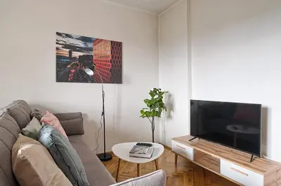 a living room with a couch and a flat screen tv at Urban Nest Apartments Starowiślna 95 in Kraków