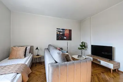 a living room with a couch and a flat screen tv at Urban Nest Apartments Starowiślna 95 in Kraków