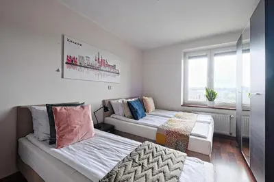 a bedroom with two beds and a window at Urban Nest Apartments Starowiślna 95 in Kraków