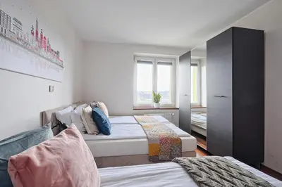 a bedroom with two beds and a window at Urban Nest Apartments Starowiślna 95 in Kraków