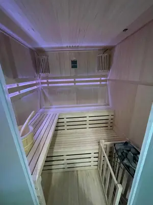 an empty sauna with purple lights in a room at Mały Książę in Podzamcze