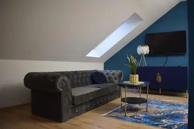 a living room with a couch and a tv at Mały Książę in Podzamcze