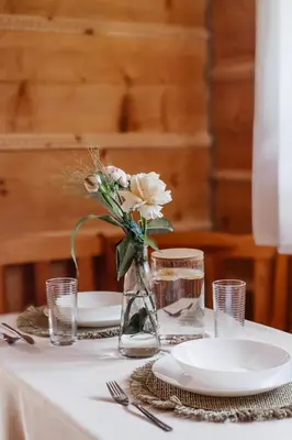 a kitchen with two tables and chairs in a cabin at Uroczy domek w Rabce-Zdrój in Rabka-Zdroj