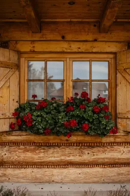 a table with two chairs and a table with flowers on it at Uroczy domek w Rabce-Zdrój in Rabka-Zdroj