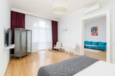 a bedroom with a bed and a living room at S18 Boutique Residence - Krakow Old Town in Kraków