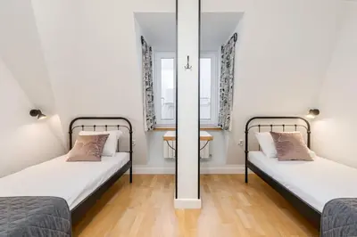 two beds in a small room with a mirror at S18 Boutique Residence - Krakow Old Town in Kraków