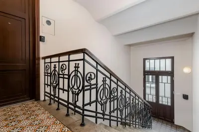 a staircase in a house with a wrought iron railing at S18 Boutique Residence - Krakow Old Town in Kraków