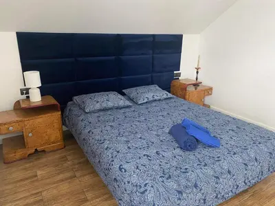 a bedroom with a large bed with a blue blanket at Beskid Family&Chill in Tenczyn