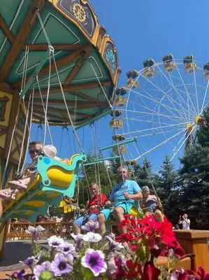 a group of people sitting on a ferris wheel at Beskid Family&Chill in Tenczyn