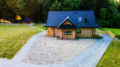a small house with a blue roof and a bunch of birds at Chałupy w Lesie Skawinki in Skawinki