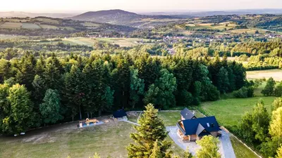 an aerial view of a house in a field with trees at Chałupy w Lesie Skawinki in Skawinki