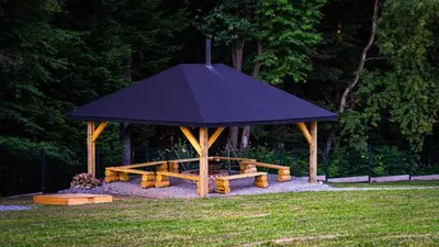 a gazebo with a picnic table in a park at Chałupy w Lesie Skawinki in Skawinki
