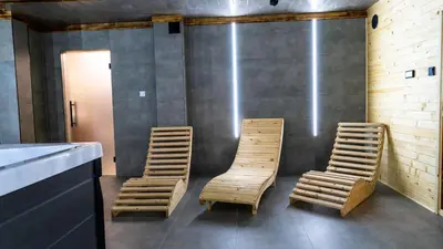 two wooden chairs sitting next to a counter in a room at Chałupy w Lesie Skawinki in Skawinki