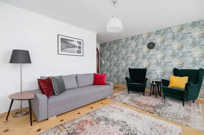 a living room with a couch and two chairs at Apartment Home Office Dobrego Pasterza Kraków by Noclegi Renters in Kraków