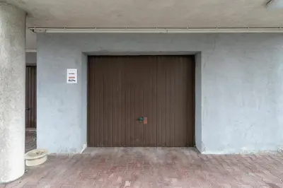 a large brown garage door in a building at Apartment Home Office Dobrego Pasterza Kraków by Noclegi Renters in Kraków