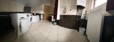 a large bathroom with a washer and dryer in it at Apartament Polański z tarasem na dachu in Rabka