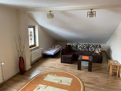 a living room with a couch and a table at Apartament Polański z tarasem na dachu in Rabka
