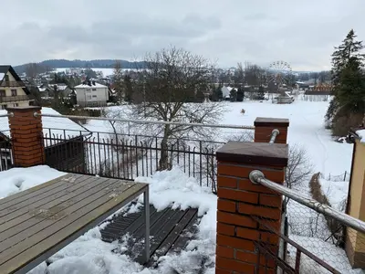 a view of a snow covered yard with a fence at Apartament Polański z tarasem na dachu in Rabka