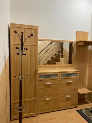 a room with a wooden cabinet and a staircase at Apartament Polański z tarasem na dachu in Rabka
