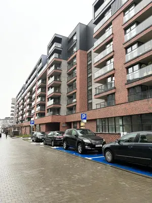 a parking lot with cars parked in front of a building at PM. Apartments Krakow in Kraków