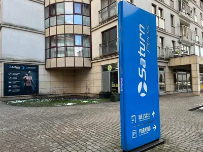 a blue sign in front of a building at PM. Apartments Krakow in Kraków