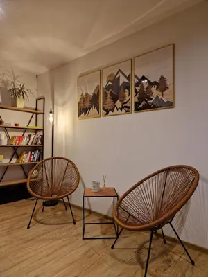 two chairs and a table in a room at Bulwary Mszańskie - Pokoje in Mszana Dolna